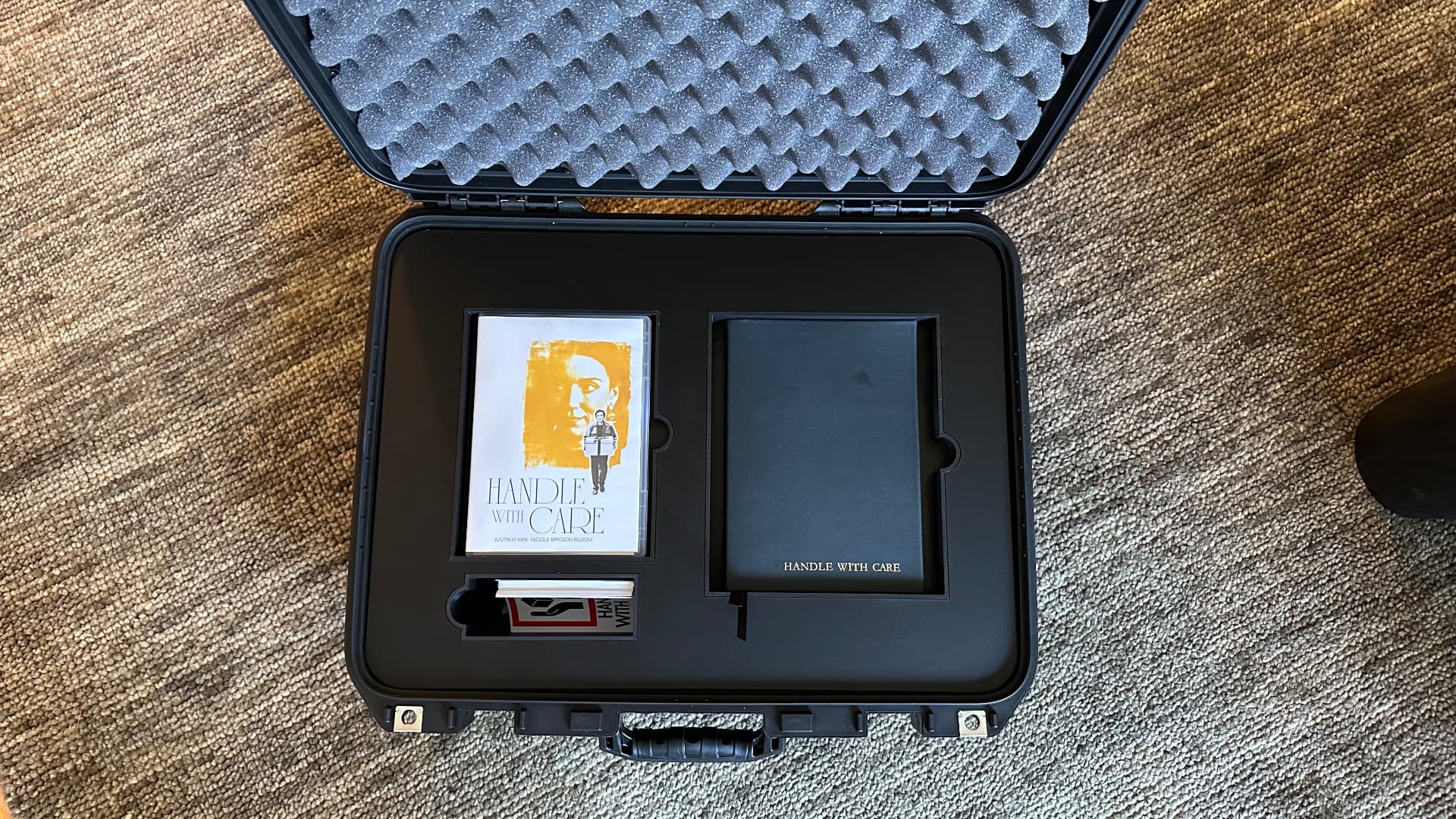 Open case with the Handle With Care DVD and movie journal
